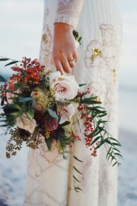 Bride holding her flower bouquet at her side.